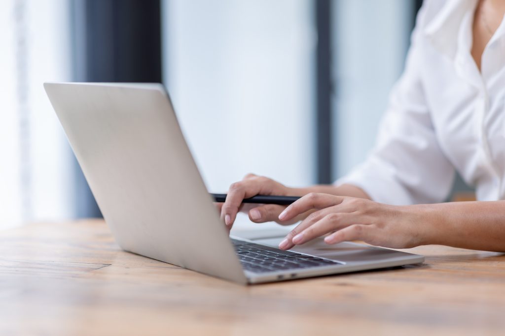 Closeup,of,hands,typing,on,a,laptop,keyboard,,freelancer,working